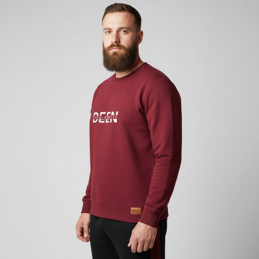 Sunnah Conscious maroon crewneck sweatshirt with white graphic text worn by a bearded man with black track pants