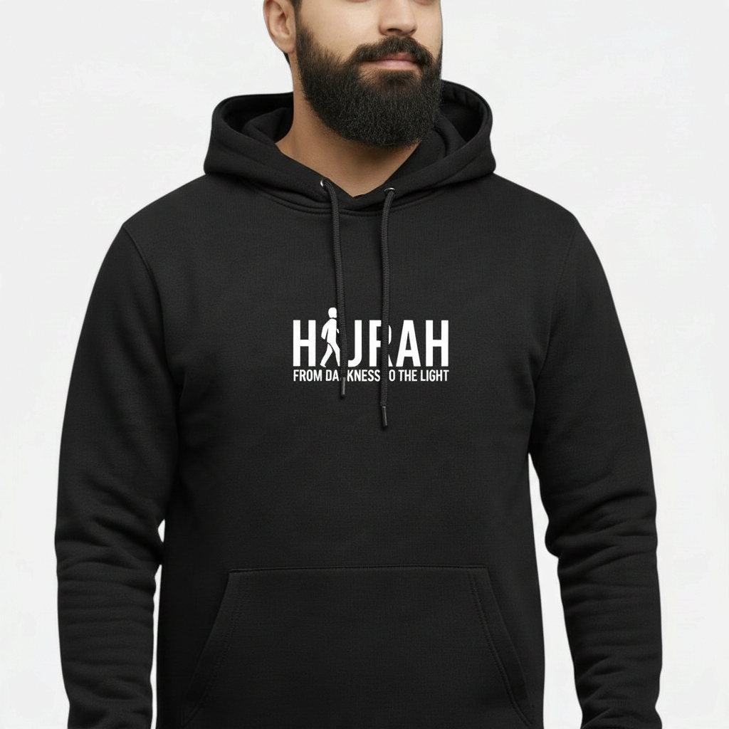 Sunnah Conscious black cotton kangaroo hoodie featuring a white Hijrah From Darkness To The Light graphic print