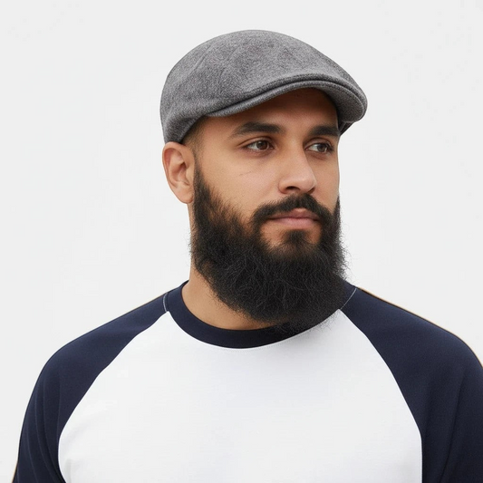 Sunnah Conscious model wearing a grey wool flat cap and a white and navy raglan sleeve shirt