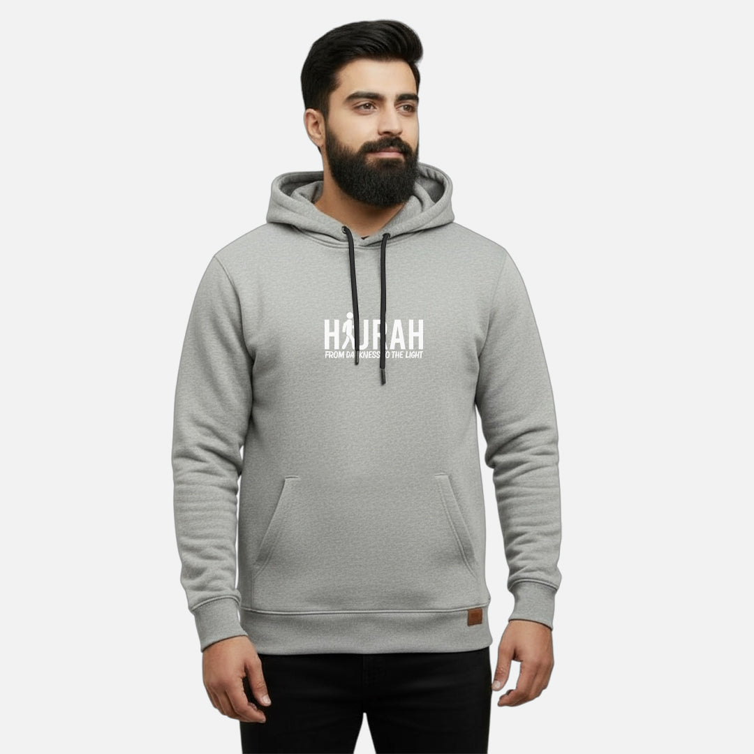 Sunnah Conscious heather grey cotton kangaroo hoodie with Hijrah From Darkness To The Light print on a bearded man