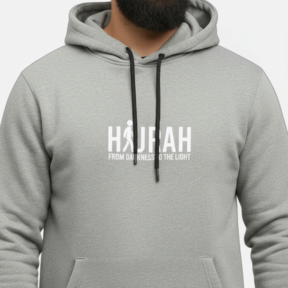 Sunnah Conscious heather grey cotton kangaroo hoodie featuring a white Hijrah From Darkness To The Light graphic.