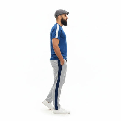 Sunnah Conscious navy blue and steel grey cotton tracksuit worn by a bearded man in a flat cap, side profile view.