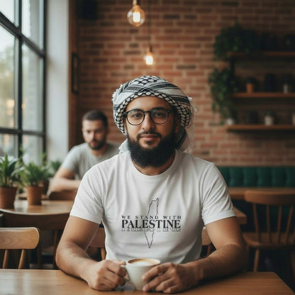 Sunnah Conscious white dry fit t-shirt with "We Stand with Palestine" graphic and map outline. Man wearing t-shirt and keffiyeh.
